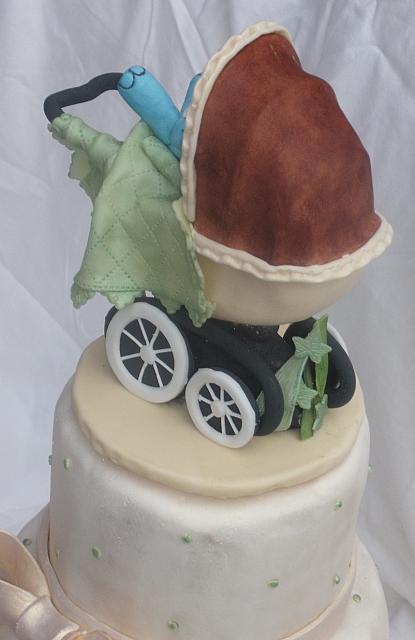 Old fashioned or old time baby carriage with blue gumpaste baby elephant back view