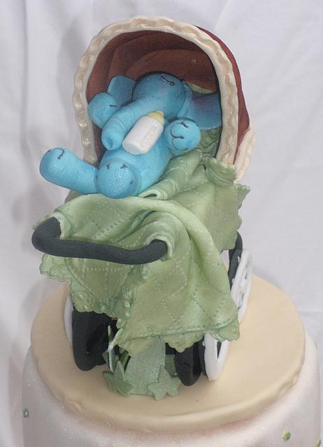 Old fashioned or old time baby carriage with blue gumpaste baby elephant inside