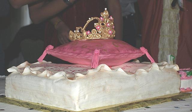 Princess themed cake of fondant covered antique book, edible pillow, and sugarpaste golden crown for baby girl - side view