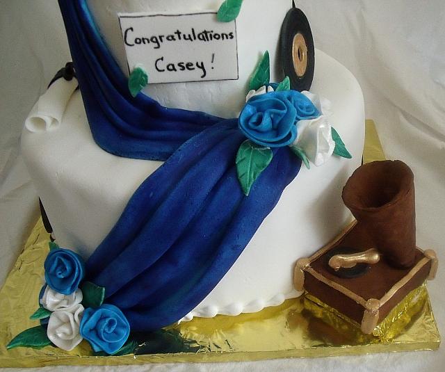 Blue and White Graduation Cake With Music Theme close up of edible, gumpaste gramophone