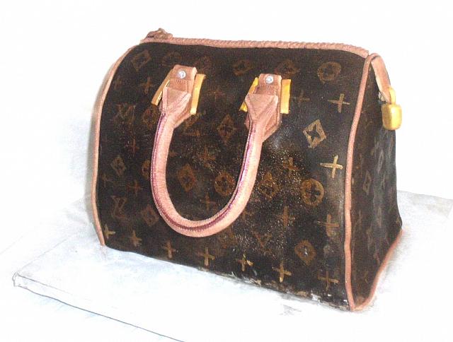 Jennifer Hernandez ordered this Louis Vuitton Fashion Purse Cake for her birthday.  She wanted the cake to be a reproduction of a purse she owned.  It is red velvet cake.  All the decorations on the purse are edible and made out of gumpaste.