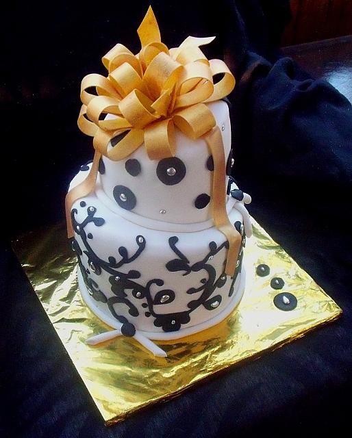 Whimsical Black and White Fondant Cake with Gold Bow and Silver Dragree Accents main view