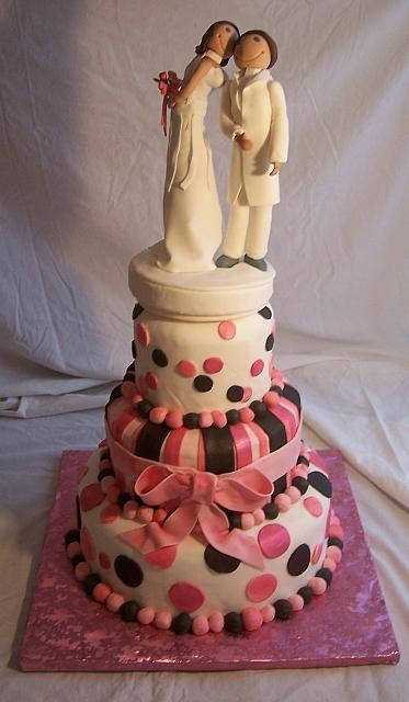 Bride Kissing Groom On Whimsical Cake