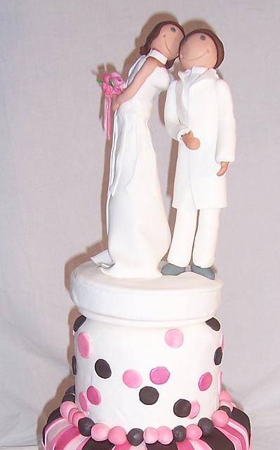 Bride Kissing Groom Figurines on Whimsical Cake
