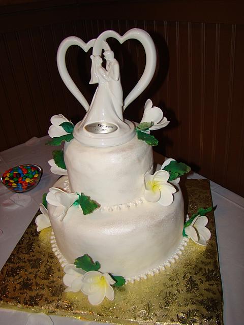 White Wedding Cake With pearl necklace fondant border and gumpaste(aka sugarpaste) Frangipani Flowers - Click on it to enlargen