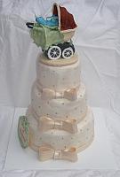 Baby Shower Cake with old fashioned baby carriage and ivory gumpaste bows on tiered cake