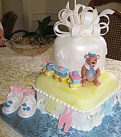 Close up of the baby shower cake with baby shoes