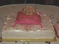 Princess themed cake of fondant covered antique book, edible pillow, and sugarpaste golden crown for baby girl -front view