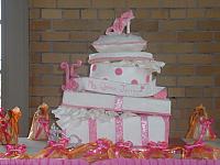 Quinceanera Cake in Pink and White with Stacked Presents, Edible Fashion Shoe, Pillow, and Princess Crown front view