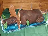 Carved Moose Cake Sitting In Pond