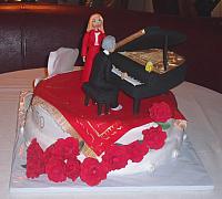 50th Anniversary Cake Couple On Oriental Rug next to Edible Grand Piano