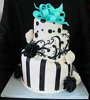 Whimsical Topsy Turvy Black and White Fondant Cake with Teal Bow and Fantasy Flowers main view