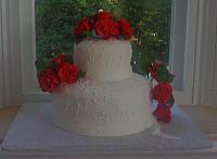 Front view of Red Roses On white fondant covered cake
